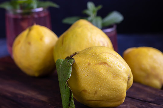 The fruits of quince. They differ in their useful properties. Suitable for food in baked, boiled form. Have a yellow color. Fruit campot in the background. Horizontal layout. Copy space. 