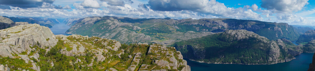 Fototapeta na wymiar Panoramic view from the top of Preikestolen fjords. Lake below and between fjords in valley