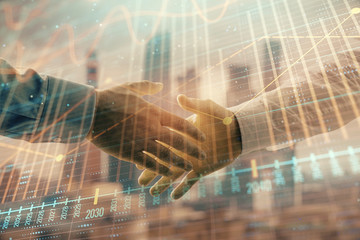 Double exposure of financial graph on cityscape background with two businessman handshake. Concept of stock market deal