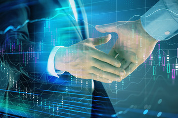 Multi exposure of forex graph on abstract background with two businessmen handshake. Concept of success on stock market