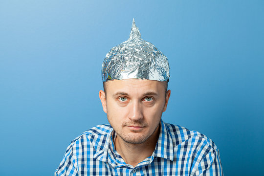 Foil hat on man. Protects from reading think