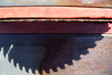 Round saw with teeth in the machine and its shadow