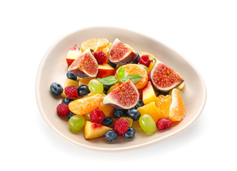 Plate with tasty fruit salad on white background