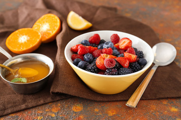 Bowl with tasty fruit salad on table