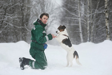Fototapeta na wymiar Two dogs walk outdoors in winter with an owner