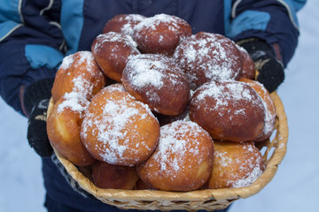 donuts christmas,boy holding a basket of delicious donuts with powdered sugar