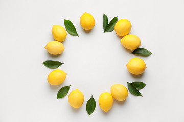 Frame made of ripe lemons on white background
