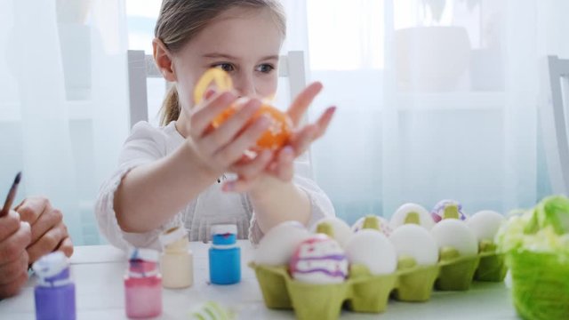 Cute pretty kid showing her wonderful Easter decorations collection