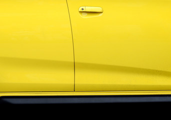 yellow door of car with handle