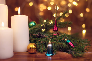 Fototapeta na wymiar Tree branches, cones, bokeh lights, candles, Christmas balls . Preparation for the New year
