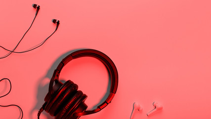 Headphones of different types flat lay on orange background, copy space. Black in ear headphones,...