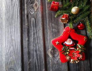 christmas santa decoration and garland lights on vintage wooden background