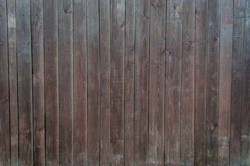 texture of a wooden fence made of boards. brown and black