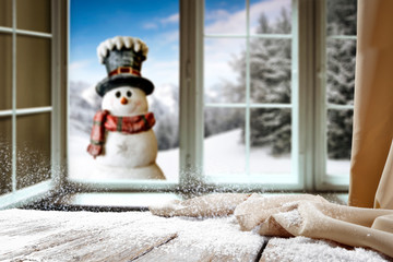 Table background of free space and blurred winter window 