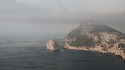 misty morning at sea and its rocky shore