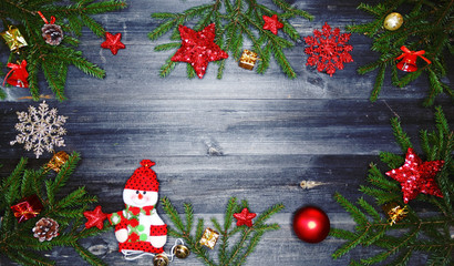 Fototapeta na wymiar christmas snowman decoration and garland lights on vintage wooden background