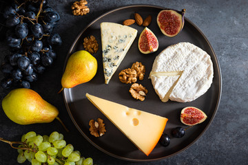 Keto, ketogenic diet, low carb, high fat healthy weight loss food. Various types of cheese, nuts ,grapes. Dairy products. Top view, close up
