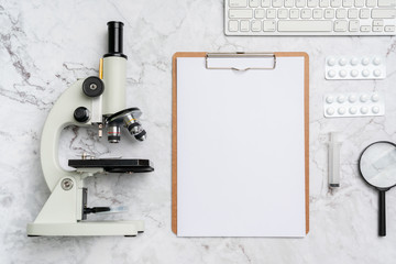 Microscope biology and chemistry subject on the desk from top view