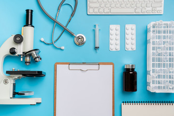 Microscope biology and chemistry subject on the desk from top view