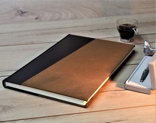 notebook and pen on wooden table