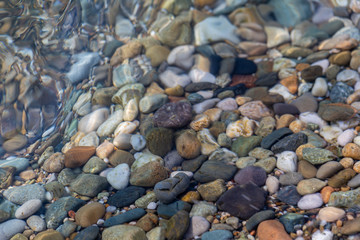 Sea pebbles on the beach in the water