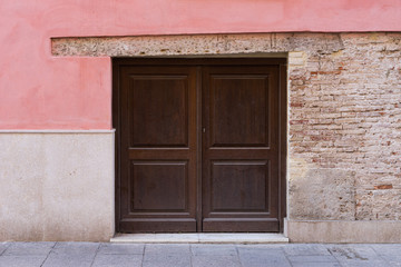 Fototapeta na wymiar Small vintage door on a brick wall. Valencia, Spain