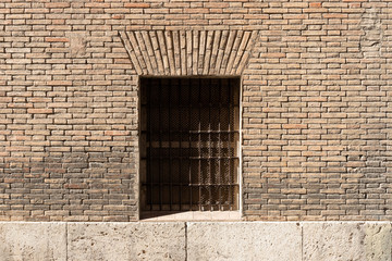 Vintage window with iron grating on a brick wall. Valencia, Spain