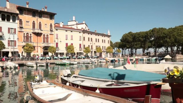 beautiful little port in italy, panning shot of the harbor inside the city centre of Desenzano del Garda