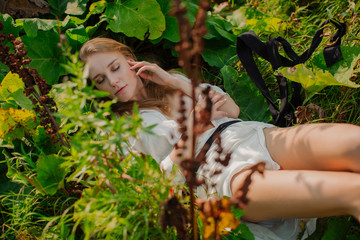 Portrait of a beautiful young girl whose face is illuminated by sunlight.