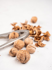 Chopped walnuts with kernels on a gray surface.