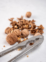 Chopped walnuts with kernels on a gray surface.