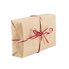From craft paper, a gift tied with a red and white rope and a bow. Isolate on a white background.