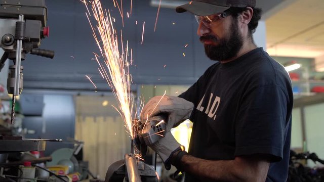 Man working on a motorbike customization. Mechanic concept.