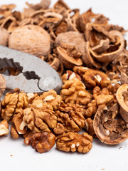 Chopped walnuts with kernels on a gray surface.