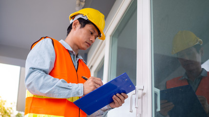 The inspector or engineer is checking the building structure and door specifications. After...