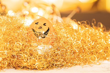 funny laughing pumpkin in a sea of gold and light