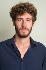 Obraz premium Face of young bearded businessman with curly hair