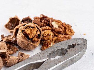 Chopped walnuts with kernels on a gray surface.