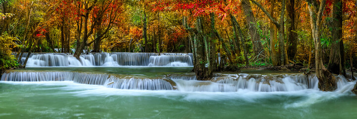 Fototapeta na wymiar Colorful majestic waterfall in national park forest during autumn, panorama - Image