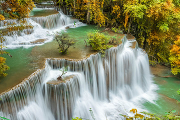 Fototapeta na wymiar Colorful majestic waterfall in national park forest during autumn - Image
