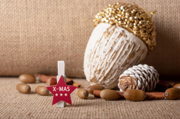 Christmas composition: Christmas star symbol, Christmas tree decoration, acorns, fir cone painted white