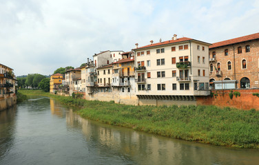 Fototapeta na wymiar Wide Bacchiglione River and the houses in Vicenza City in italy
