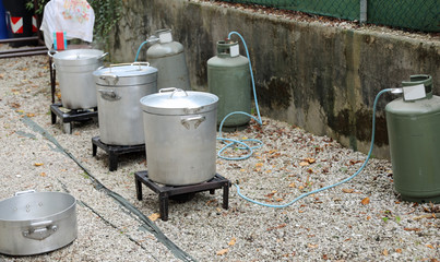 outdoor kitchen with many big cauldrons