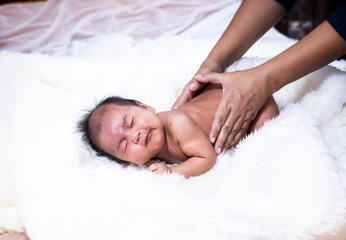 In selective focus of  baby was massaging by therapist hands,for relax time,Stimulate the development of newborns