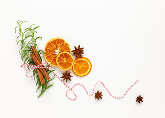  Christmas composition with dried oranges and spices on white background. Natural food ingredient for cooking or Christmas decor for home. Flat lay.