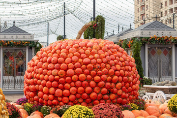 Large pumpkin collected from small orange pumpkins, decoration for the harvest festival or Halloween.
