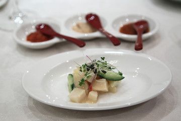 Chinese baked scallops with cucumber on white plate