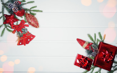 christmas decoration and red gift boxes on white wooden background