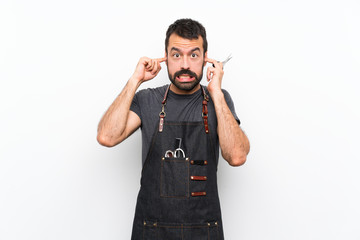 Fototapeta premium Barber man in an apron frustrated and covering ears