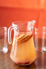 Fruit punch in a glass pitcher. A refreshing summer beverage served in a restaurant.